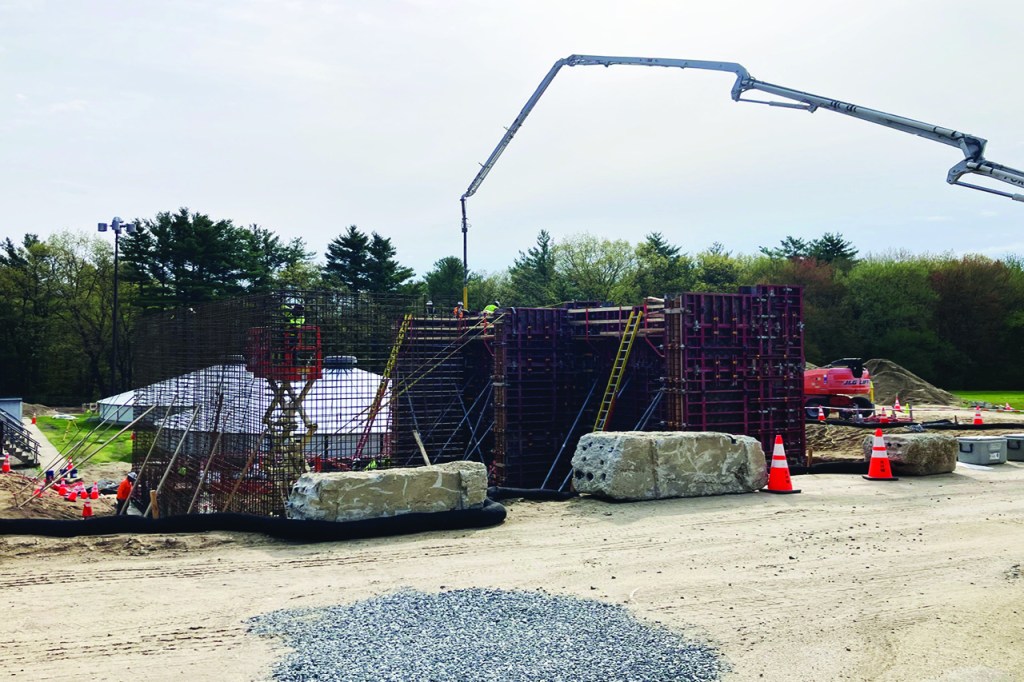 Crane during construction of sludge holding tanks showing rebar construction